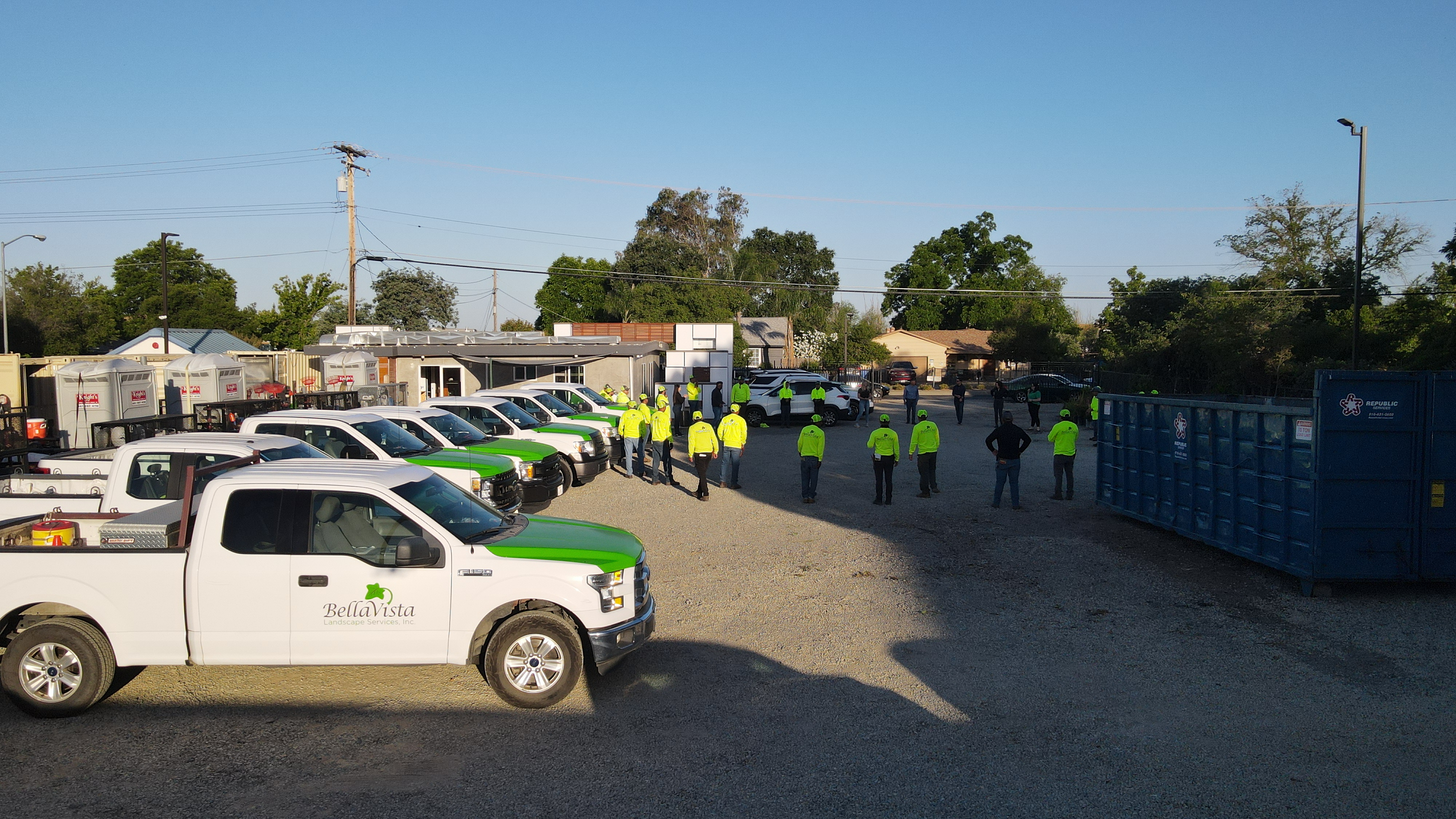 BellaVista employees gather for their morning stretch, surrounded by fleet vehicles.