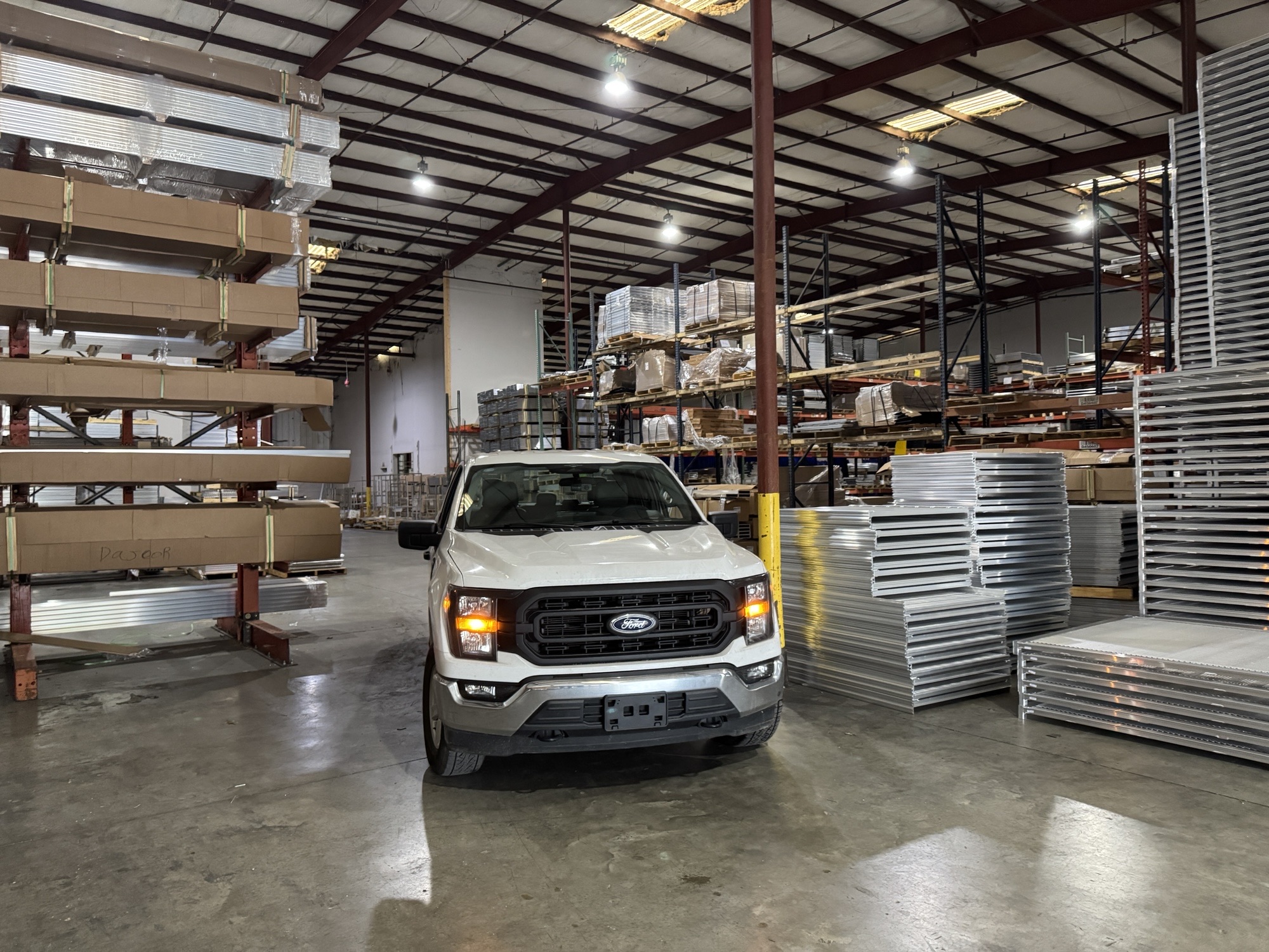 A white truck in a warehouse