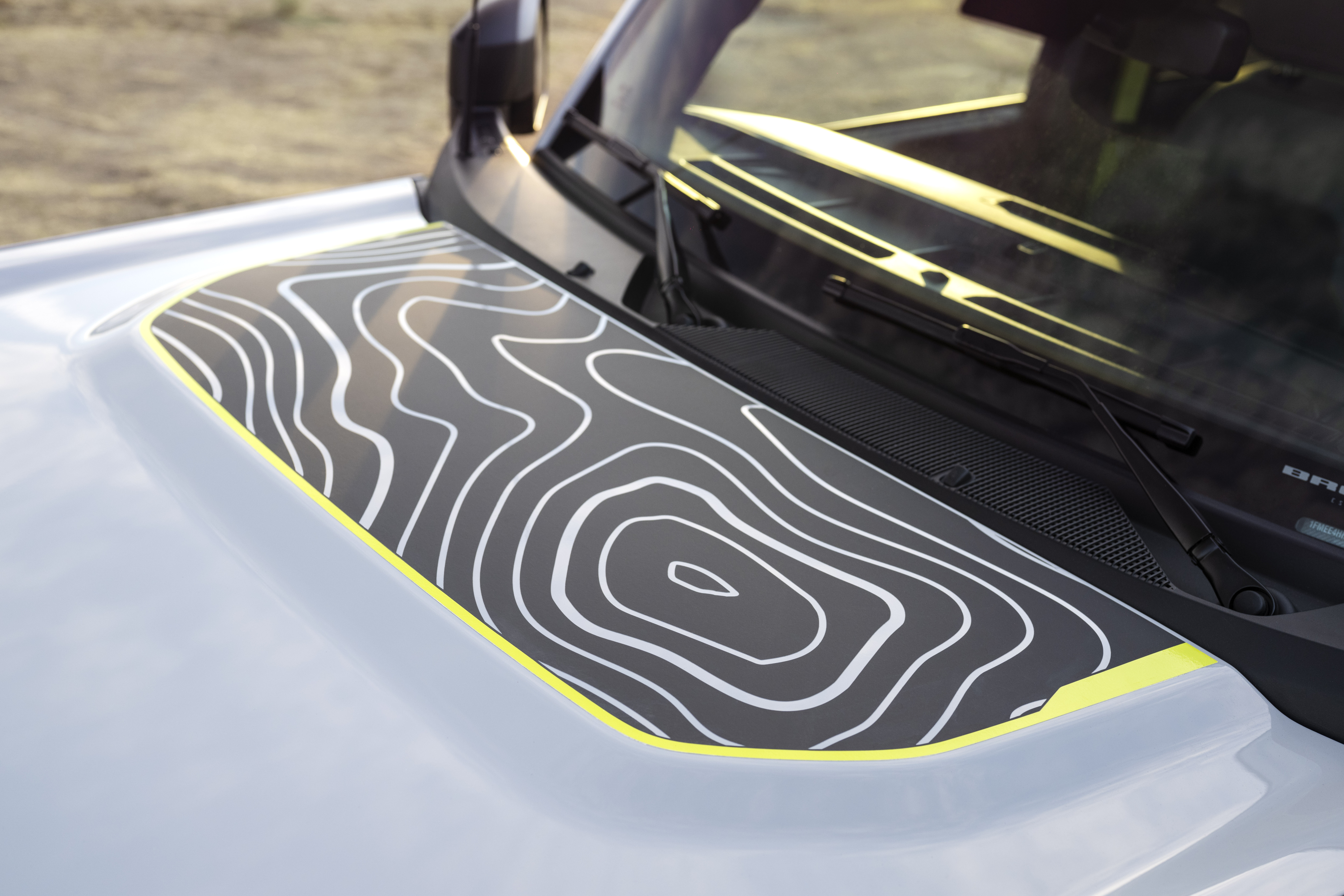 Lime green highlights and topographical map-like design shown on the hood of the Bronco RTR.