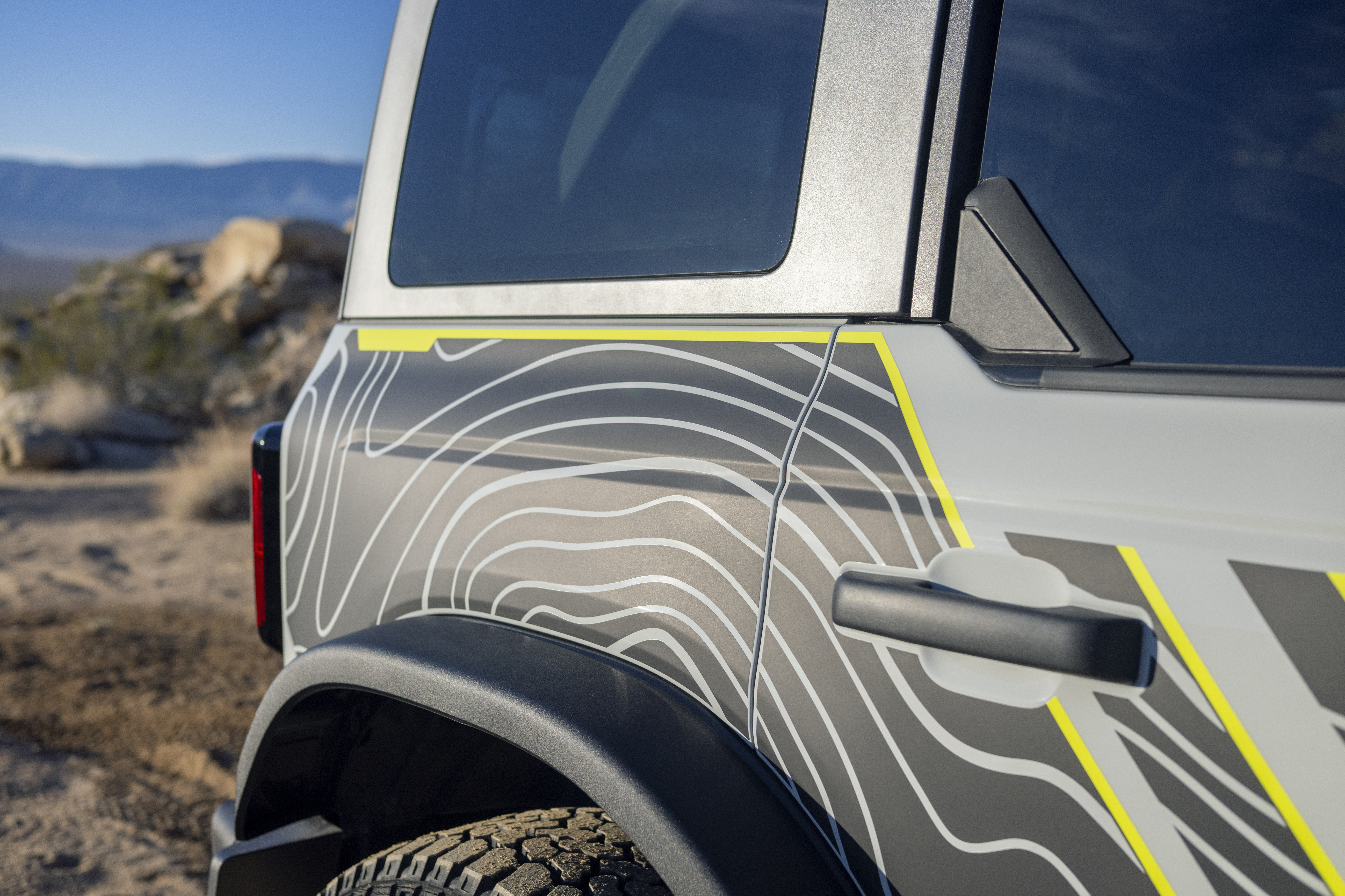 Lime green highlights and topographical map-like design shown on the side of the Bronco RTR.