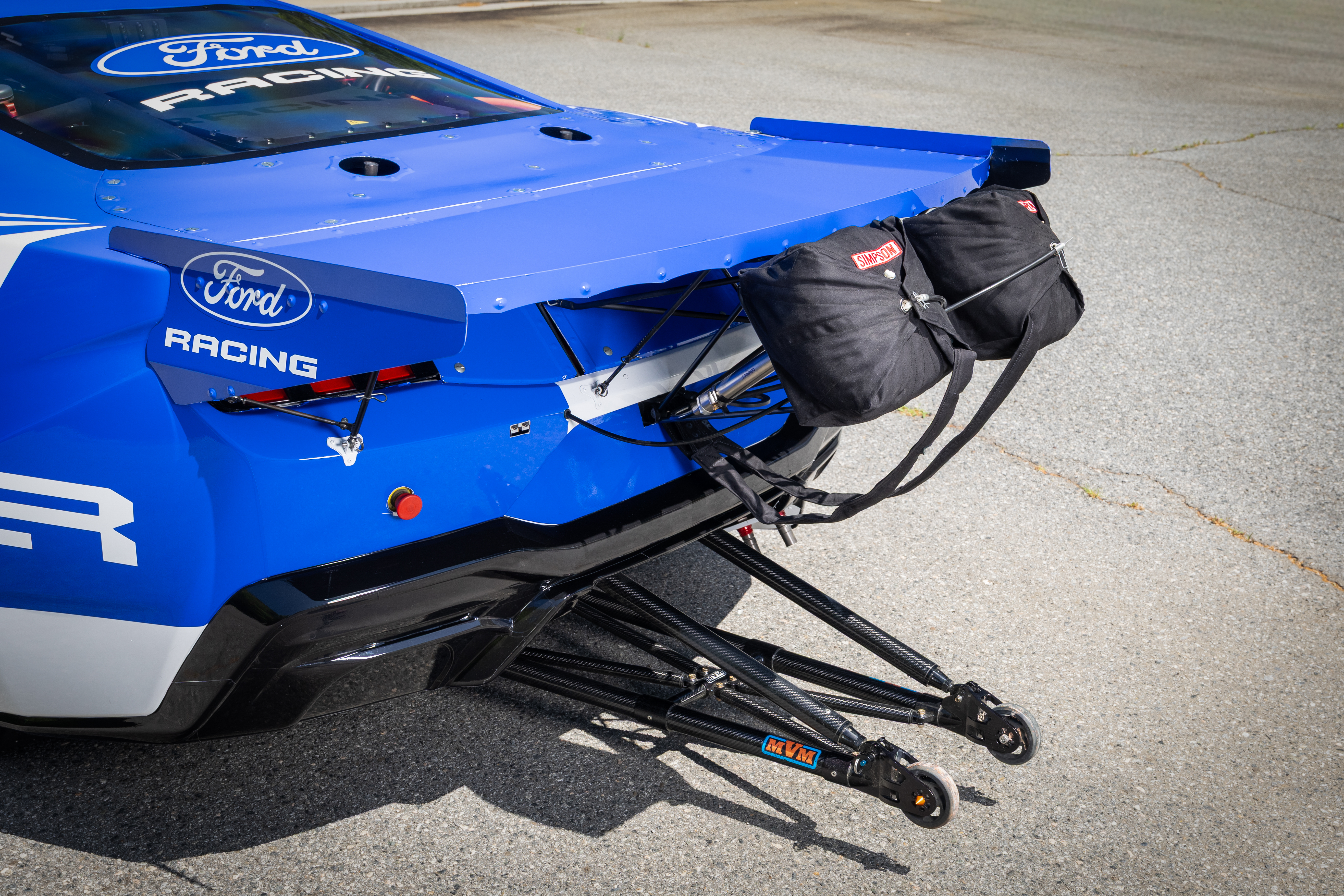 Ford Racing Mustang Cobra Jet 2200 rear view with wheelie bars and parachutes