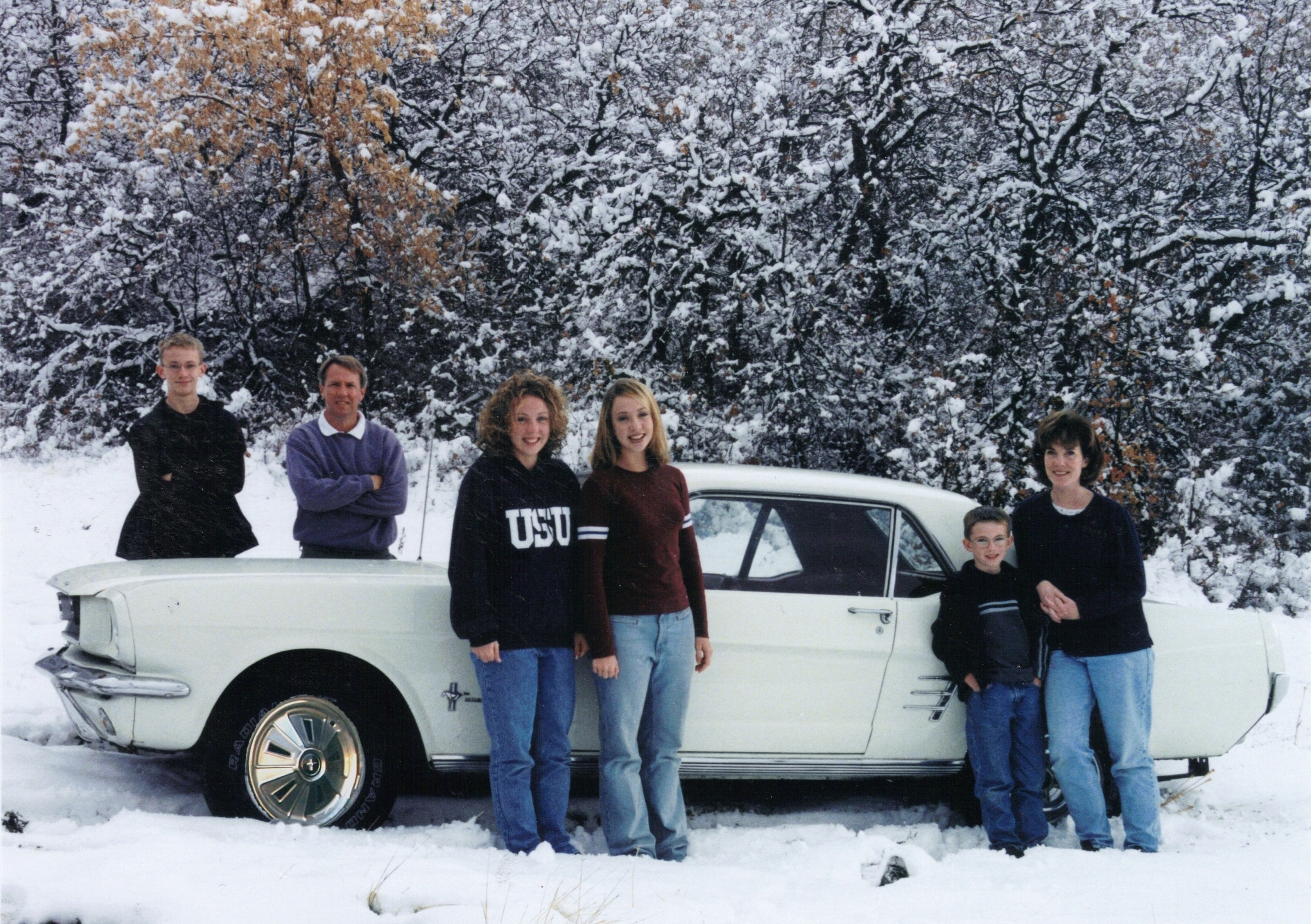 The family Mustang is at the center of each family photo from 1998 to 2025.