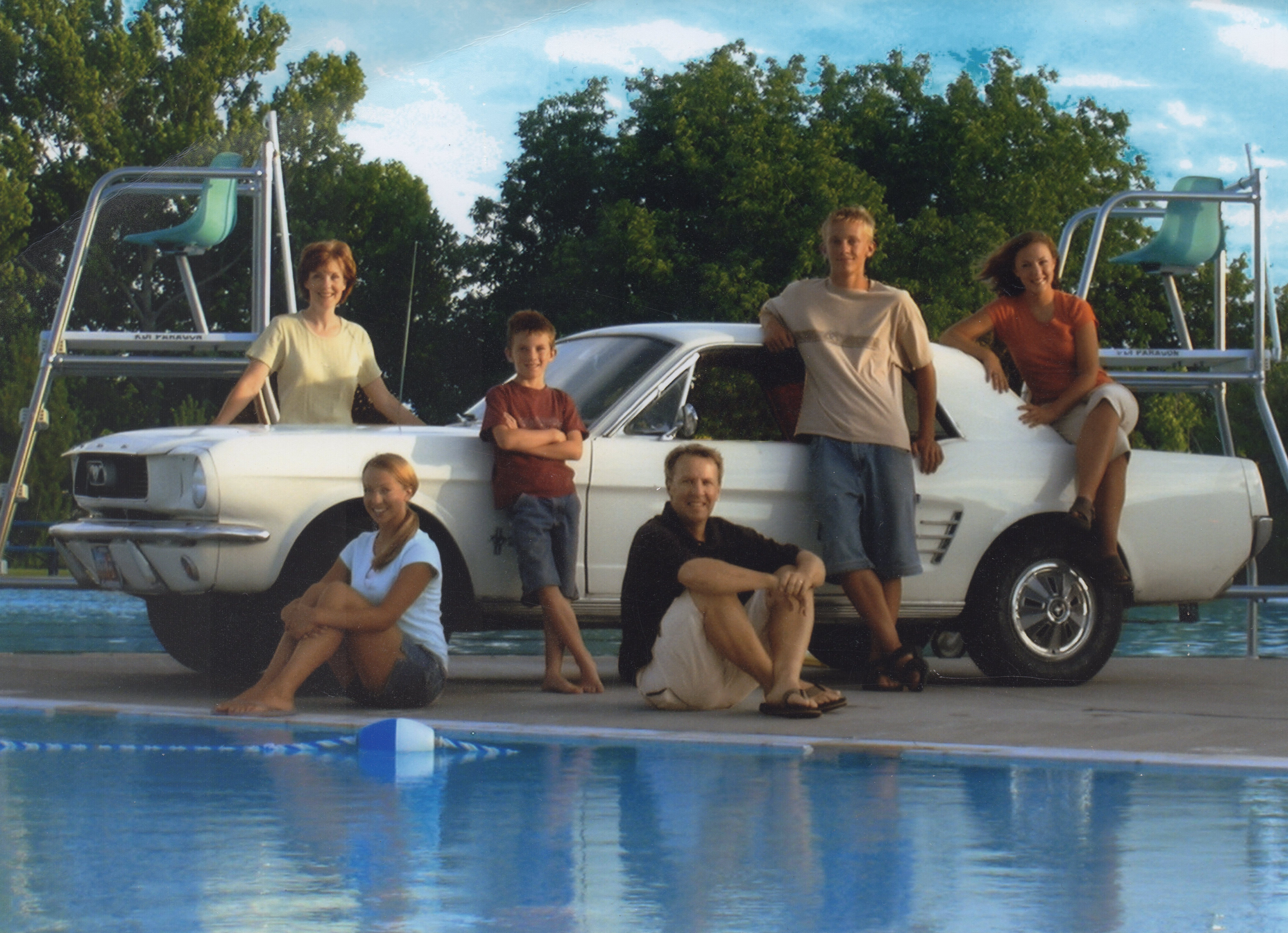 The family Mustang is at the center of each family photo from 1998 to 2025.