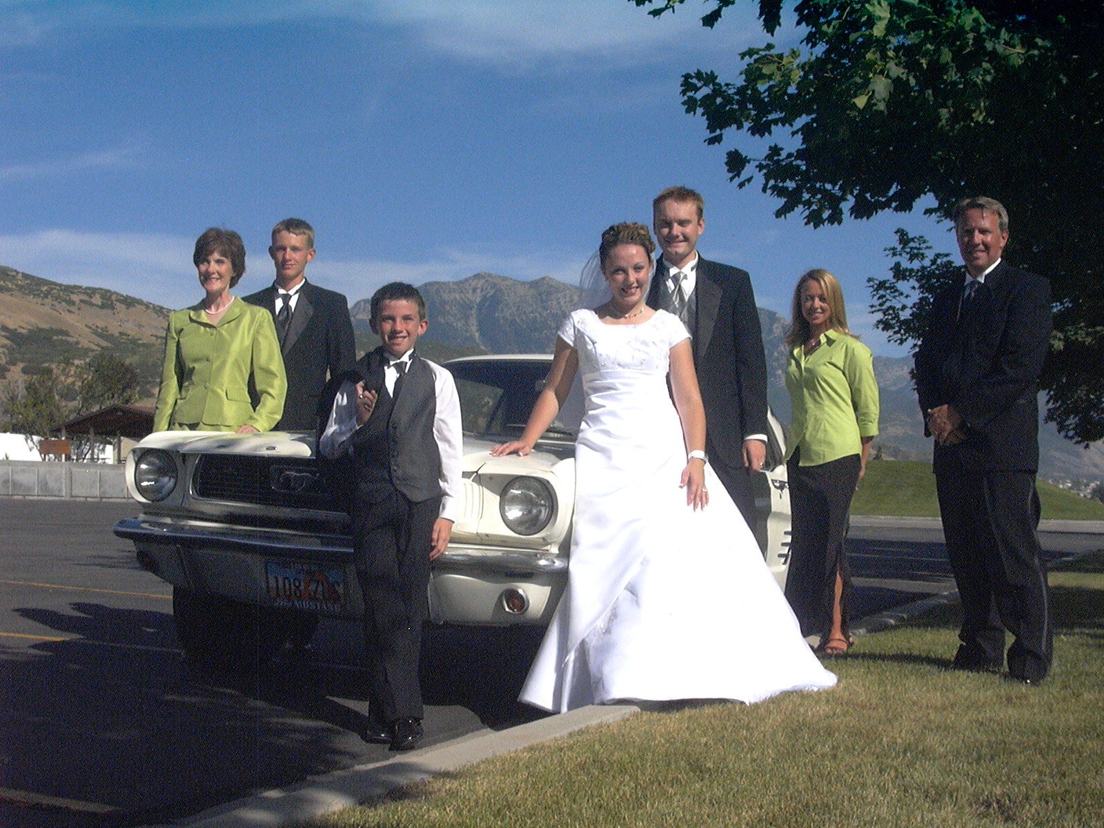 The family Mustang is at the center of each family photo from 1998 to 2025.