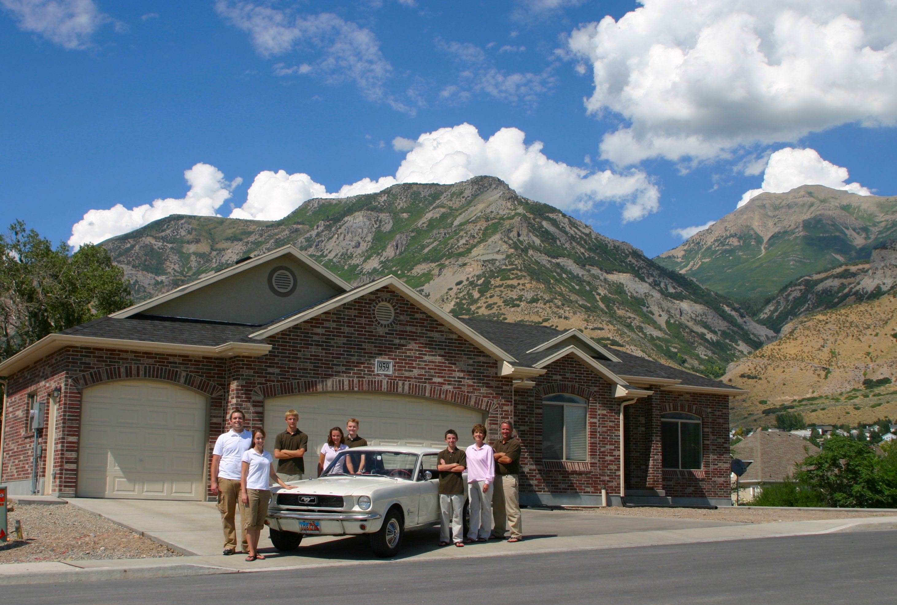 The family Mustang is at the center of each family photo from 1998 to 2025.