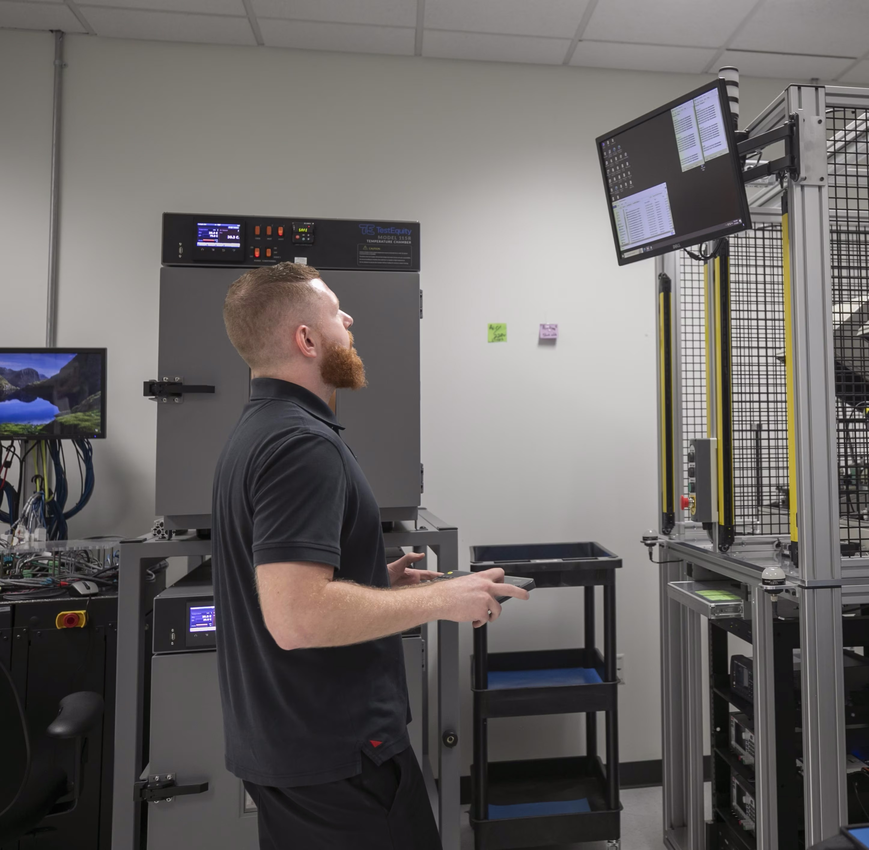 An engineer touches a computer screen.