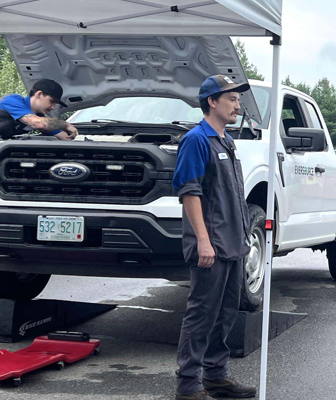 Ford Mobile Service technician Dave Bosquet talks with Governor Ayotte during a food drive on July 31 where Grappone Ford offered complimentary oil changes in exchange for donated goods. Bosquet attended the Boys and Girls Club when he was younger. 